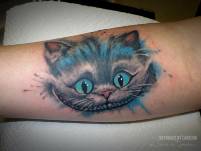 daniel_herrmann_tattoo_grinsekatze_alice_wunderland_cheshire_cat